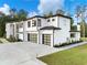Contemporary home showcasing clean lines, modern garage doors, and a well-maintained yard at 2940 Old Peachtree Rd, Dacula, GA 30019