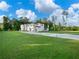 Expansive home with modern architecture, a long driveway, and a sprawling green lawn at 2940 Old Peachtree Rd, Dacula, GA 30019