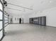 Large garage with epoxy flooring, storage solutions, and natural light, perfect for car enthusiasts and hobbyists at 2940 Old Peachtree Rd, Dacula, GA 30019