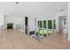 Bright hallway featuring hardwood floors, glass railing, and an abundance of natural light from the large windows at 2940 Old Peachtree Rd, Dacula, GA 30019