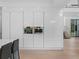 Modern kitchen features sleek, white cabinetry with built-in appliances at 2940 Old Peachtree Rd, Dacula, GA 30019