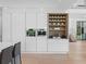 Modern kitchen features sleek, white cabinetry with built-in oven and coffee bar at 2940 Old Peachtree Rd, Dacula, GA 30019