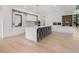 Modern kitchen with large island, breakfast bar, and sleek white cabinets at 2940 Old Peachtree Rd, Dacula, GA 30019