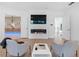 Modern living room featuring a linear fireplace, TV, and an open layout with access to the hallway and other rooms at 2940 Old Peachtree Rd, Dacula, GA 30019