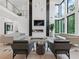 Open-concept living space with fireplace, soaring windows, and stylish furnishings at 2940 Old Peachtree Rd, Dacula, GA 30019