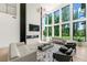Bright living room with soaring windows, sleek fireplace, and modern decor at 2940 Old Peachtree Rd, Dacula, GA 30019