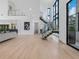 Open-concept living space with staircase, modern lighting, and sleek finishes at 2940 Old Peachtree Rd, Dacula, GA 30019