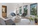 Modern living room featuring chairs, accent table, and large windows offering a view of the surrounding greenery at 2940 Old Peachtree Rd, Dacula, GA 30019