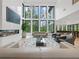 Bright living room with modern fireplace, high ceilings, floor-to-ceiling windows, and stylish decor at 2940 Old Peachtree Rd, Dacula, GA 30019