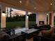 Covered outdoor living area with fireplace, fire pit, and ample seating at 2940 Old Peachtree Rd, Dacula, GA 30019