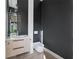 Chic powder room featuring modern fixtures, a floating vanity, and stylish accents in a contemporary design at 2940 Old Peachtree Rd, Dacula, GA 30019