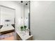 Stylish half-bathroom with a floating vanity, vessel sink, modern fixtures, and minimalist decorations at 2940 Old Peachtree Rd, Dacula, GA 30019