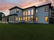 Modern home featuring expansive windows, a covered patio and lush landscaping with a manicured lawn at 2940 Old Peachtree Rd, Dacula, GA 30019