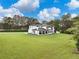 Expansive backyard featuring a covered patio and a pristine lawn, perfect for outdoor enjoyment at 2940 Old Peachtree Rd, Dacula, GA 30019