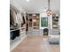 Spacious walk-in closet with custom shelving, drawers, ample storage, vanity, and a stylish seating area at 2940 Old Peachtree Rd, Dacula, GA 30019