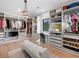 Open walk-in closet with custom shelves, cabinets, and drawers with an ample amount of room for clothes and accessories at 2940 Old Peachtree Rd, Dacula, GA 30019