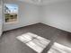 Inviting bedroom with neutral carpeting and a bright window offering natural light at 2985 Whittier Way, Cumming, GA 30040