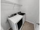 Convenient laundry room with modern washer and dryer, plus overhead shelving at 2985 Whittier Way, Cumming, GA 30040