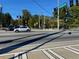 A street view of a roadway intersection with traffic lights and vehicles on a bright, sunny day at 3155 Oakcliff Nw Rd, Atlanta, GA 30311