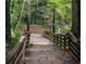 Wooden walkway with railings through a wooded landscape. Enjoy nature at 3155 Oakcliff Nw Rd, Atlanta, GA 30311