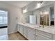 Bathroom featuring a double sink vanity, large mirror, and tile flooring at 4825 Odum View Ln, Cumming, GA 30040