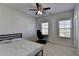 This bedroom has two windows, a ceiling fan, carpet and neutral walls at 4825 Odum View Ln, Cumming, GA 30040