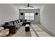 Spacious bonus room with plush carpeting, a comfortable sectional sofa and a window bringing in natural light at 4825 Odum View Ln, Cumming, GA 30040