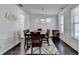 Bright dining room featuring hardwood floors, a pendant light, and stylish chair rail molding at 4825 Odum View Ln, Cumming, GA 30040