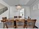 This dining room features a large wooden table, seating for eight, and a modern light fixture at 4825 Odum View Ln, Cumming, GA 30040