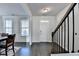 Bright entryway featuring hardwood floors, a staircase, and a freshly painted white front door at 4825 Odum View Ln, Cumming, GA 30040