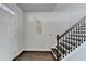 Bright entryway featuring hardwood floors, a staircase, and a freshly painted white front door at 4825 Odum View Ln, Cumming, GA 30040