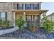 Cozy front porch with detailed columns and landscaping offering a welcoming entrance to the home at 4825 Odum View Ln, Cumming, GA 30040