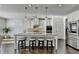 Bright kitchen features a granite island with seating and stainless steel appliances at 4825 Odum View Ln, Cumming, GA 30040
