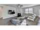 Comfortable living room with fireplace, ceiling fan and plush seating at 4825 Odum View Ln, Cumming, GA 30040
