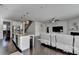 Open living room and kitchen featuring hardwood floors and stainless steel appliances at 4825 Odum View Ln, Cumming, GA 30040