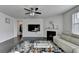 Cozy living room with fireplace, large TV, and natural light at 4825 Odum View Ln, Cumming, GA 30040