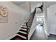 Elegant staircase with wood treads and iron railings, leading to an open floor plan at 4825 Odum View Ln, Cumming, GA 30040