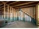 Unfinished basement space featuring framed walls, insulation and staircase at 5928 Cobblestone Creek Cir, Mableton, GA 30126