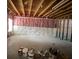 Unfinished basement with exposed beams, pink insulation, and bare concrete floor at 5928 Cobblestone Creek Cir, Mableton, GA 30126