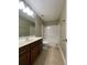 Bathroom featuring tile floors, a soaking tub, and a vanity sink at 5928 Cobblestone Creek Cir, Mableton, GA 30126