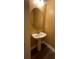 Bathroom featuring hardwood floors, neutral walls, and pedestal sink at 5928 Cobblestone Creek Cir, Mableton, GA 30126