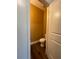 Small powder room with hardwood floors, neutral walls, and a white toilet at 5928 Cobblestone Creek Cir, Mableton, GA 30126