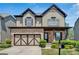 Charming two-story home featuring stone accents, a two-car garage, and a beautifully landscaped front yard at 5928 Cobblestone Creek Cir, Mableton, GA 30126