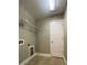 Bright laundry room with overhead shelving and a neutral color palette at 5928 Cobblestone Creek Cir, Mableton, GA 30126