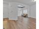Bright, open-concept living room with hardwood floors, large windows, and neutral paint colors at 5928 Cobblestone Creek Cir, Mableton, GA 30126