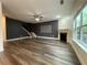 Open concept living room with hardwood floors, fireplace, and ample natural light at 5928 Cobblestone Creek Cir, Mableton, GA 30126