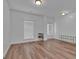 Clean living room with hardwood floors, a rear entry door, and bright white walls at 5928 Cobblestone Creek Cir, Mableton, GA 30126