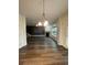 Open living room features a fireplace, wood floors, and modern light fixture at 5928 Cobblestone Creek Cir, Mableton, GA 30126