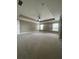 Spacious main bedroom featuring tray ceilings and neutral carpet at 5928 Cobblestone Creek Cir, Mableton, GA 30126