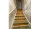 Staircase leading up with unfinished wooden steps and a white handrail at 5928 Cobblestone Creek Cir, Mableton, GA 30126